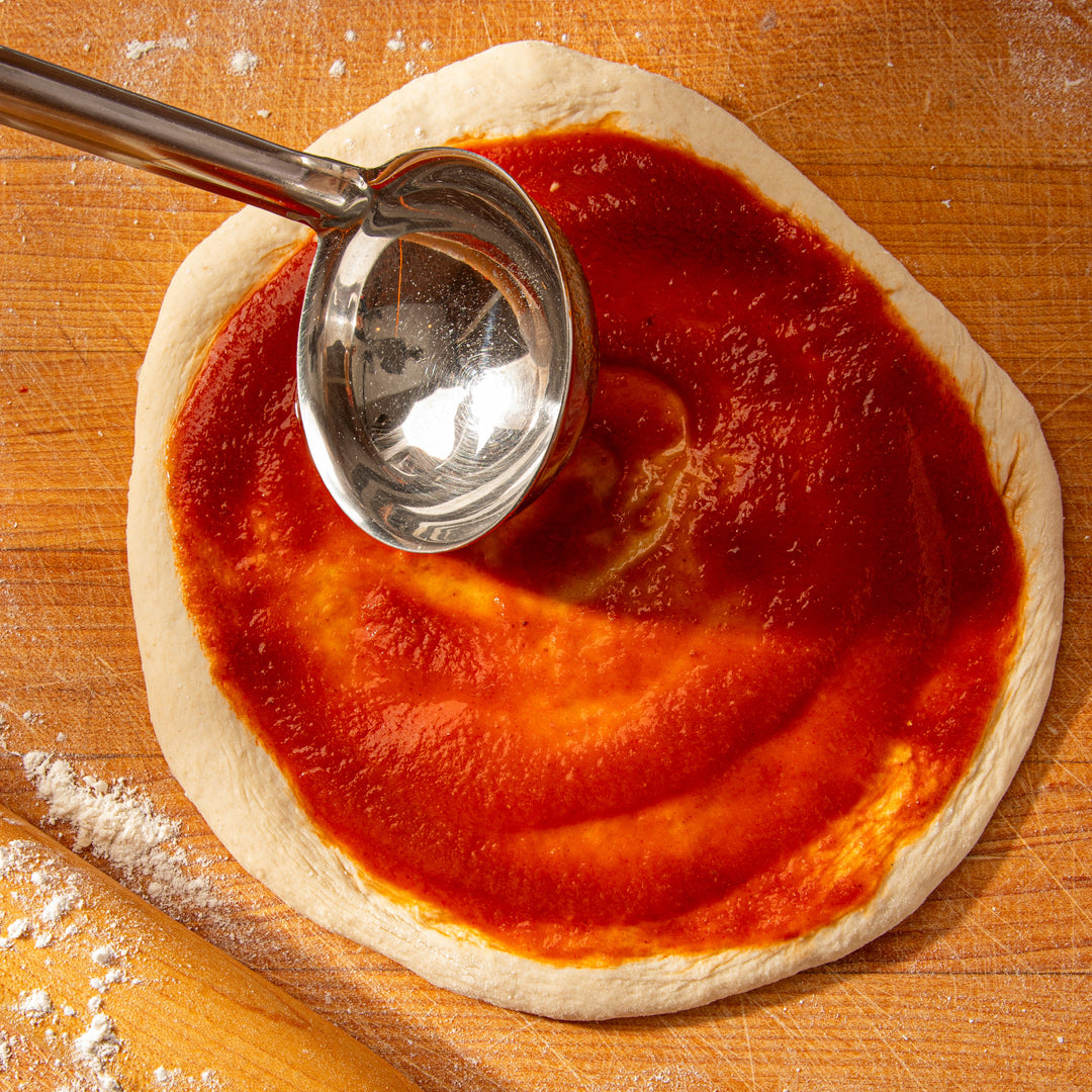 Matriark passata+ spread on pizza dough